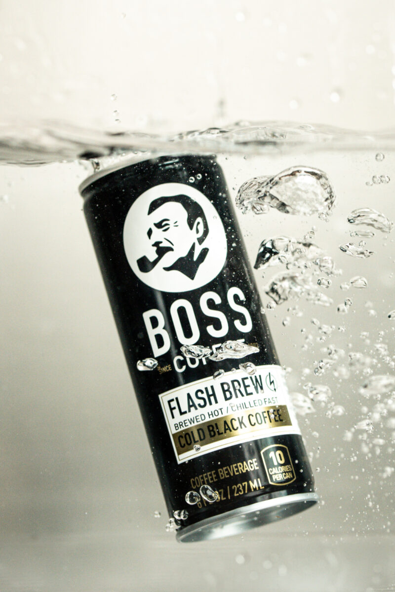A can of BOSS Coffee dunked in water