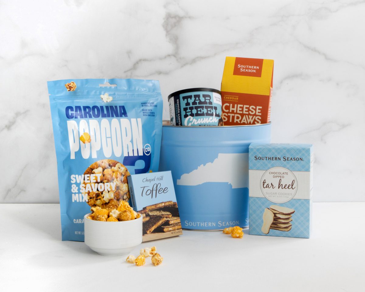 An assortment of Southern Season products, including Carolina Popcorn, Chapel Hill Toffee, Tar Heel Crunch, Cheese Straws and a Tar Heel Tin.