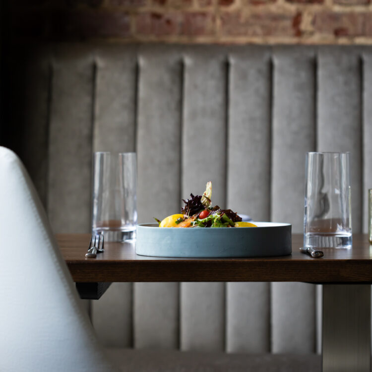 Erbario Tuscano diffusers set on a dark background and styled on gold, mirrored trays.