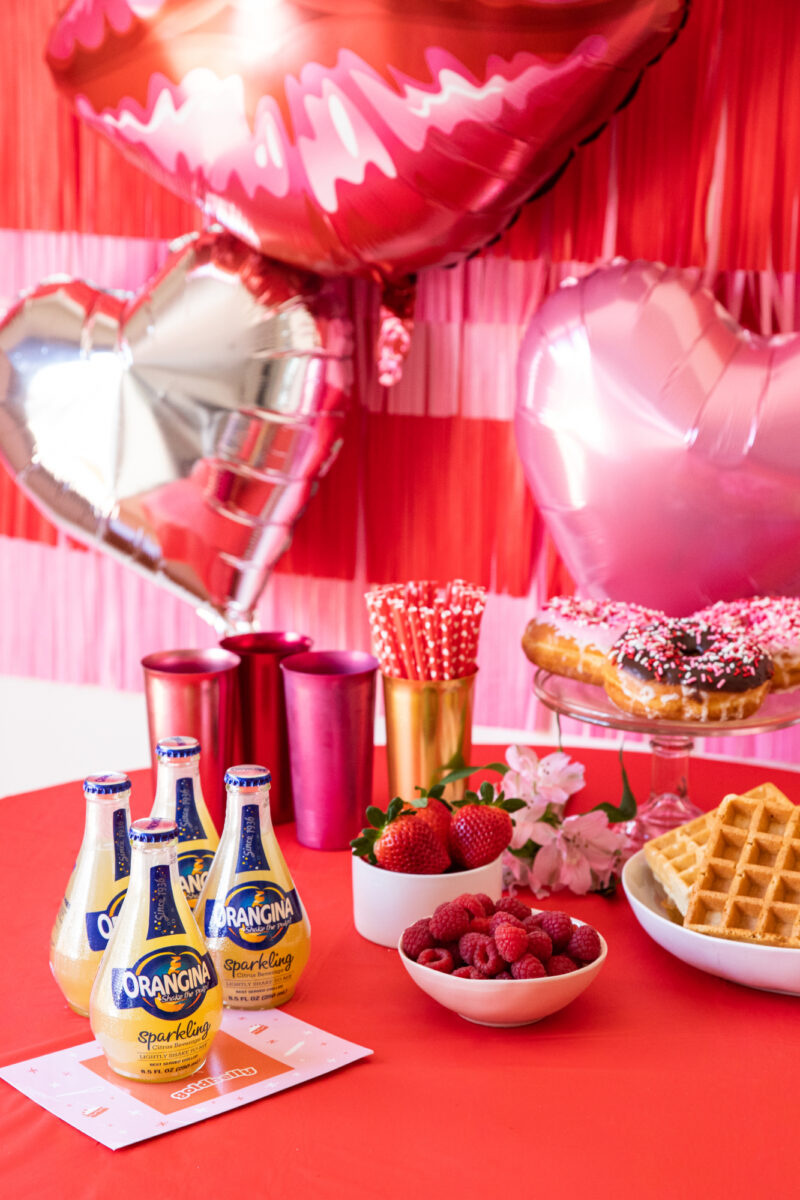 Galentines Party table spread with Orangina bottles