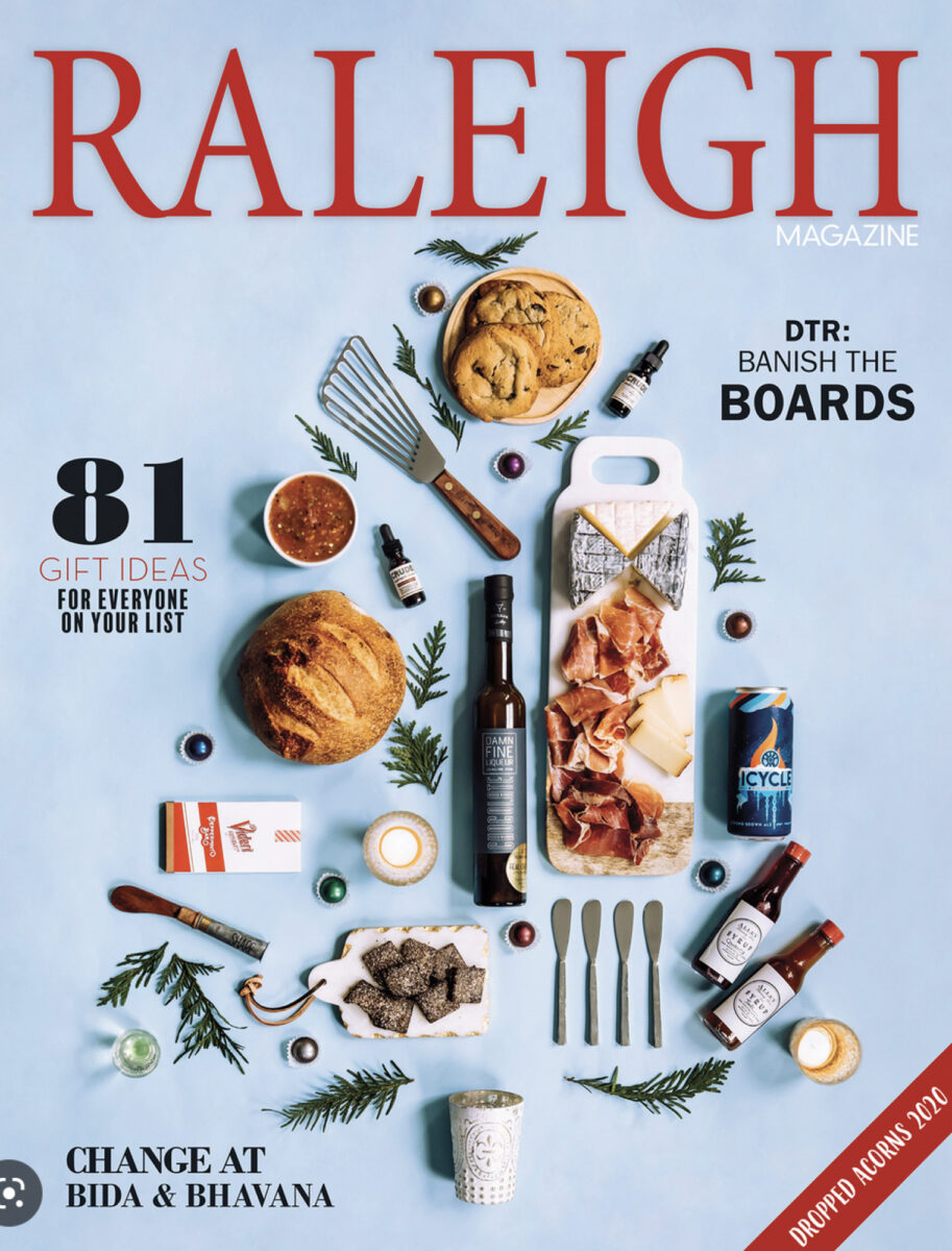 Gift Ideas photographed from above that are aligned in the shape of a Christmas tree with a headline of 81 Gift Ideas for Everyone on Your List – Raleigh Magazine