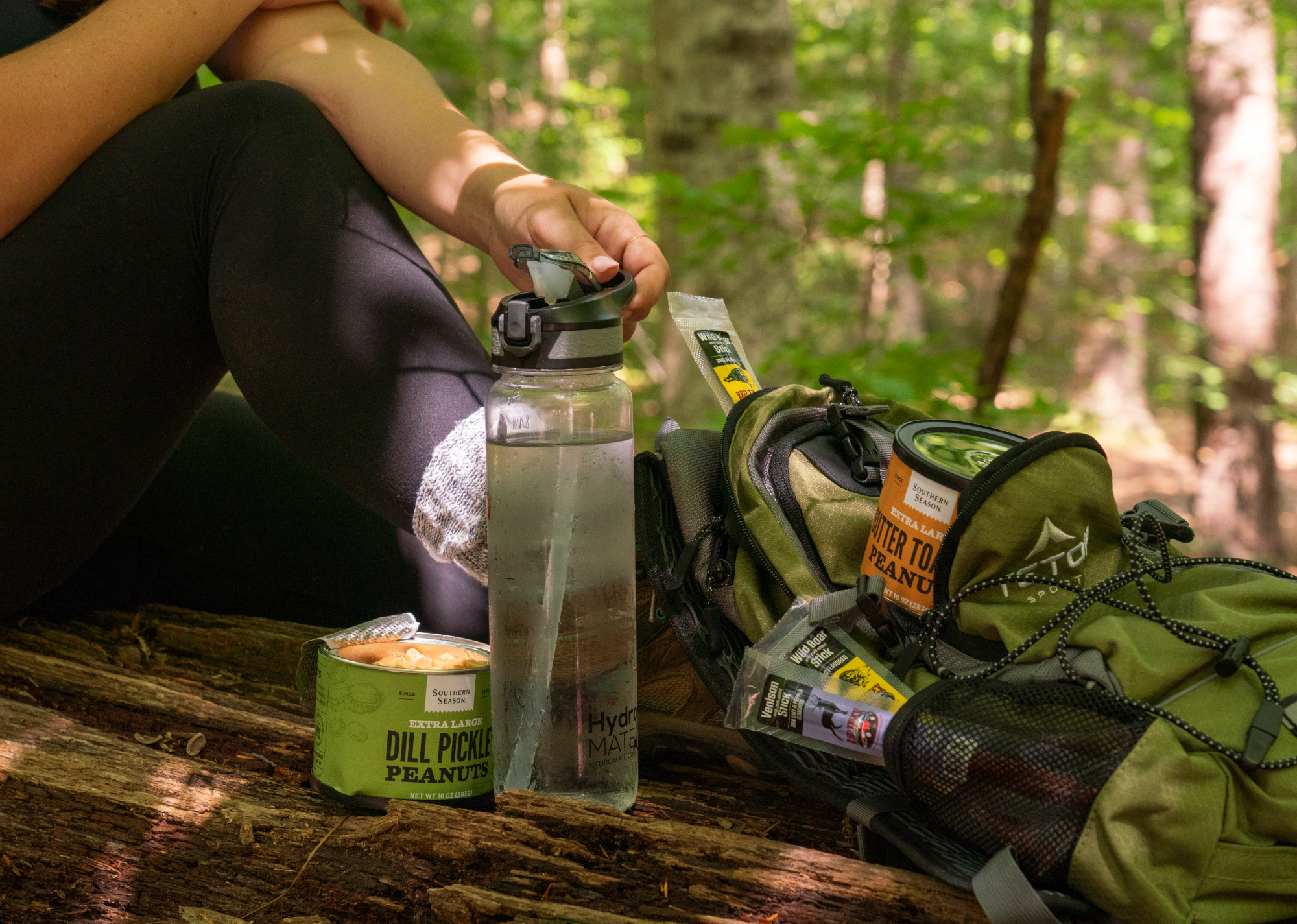 Stopping for a snack while on the trail, hiking with a backpack full of Southern Season Peanuts