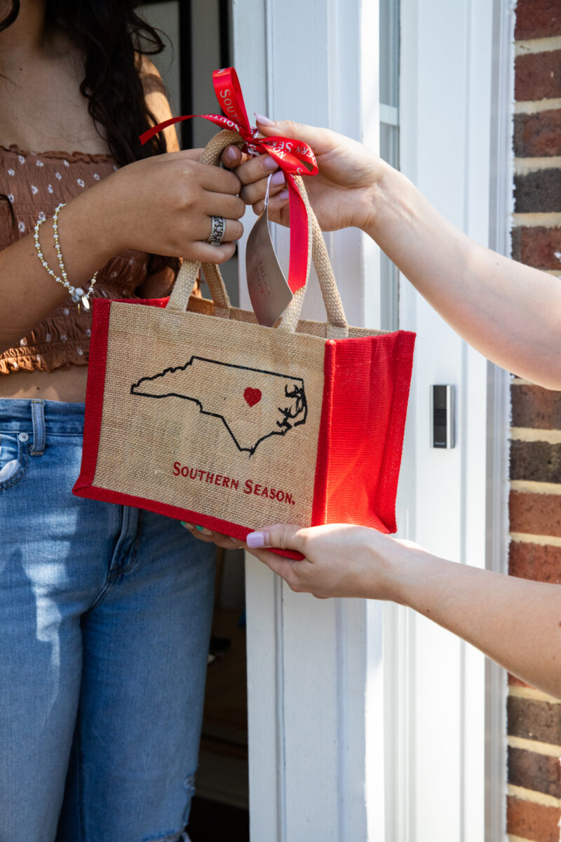 Southern Season's Small Gift Bag Set being handed to the hostess of a party