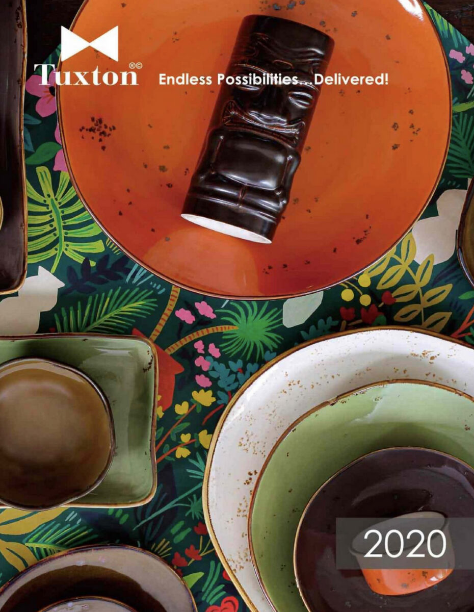 Tuxton's 2020 Catalog Cover with Tiki inspired dinnerware, plates and bowls on a tropical tablecloth