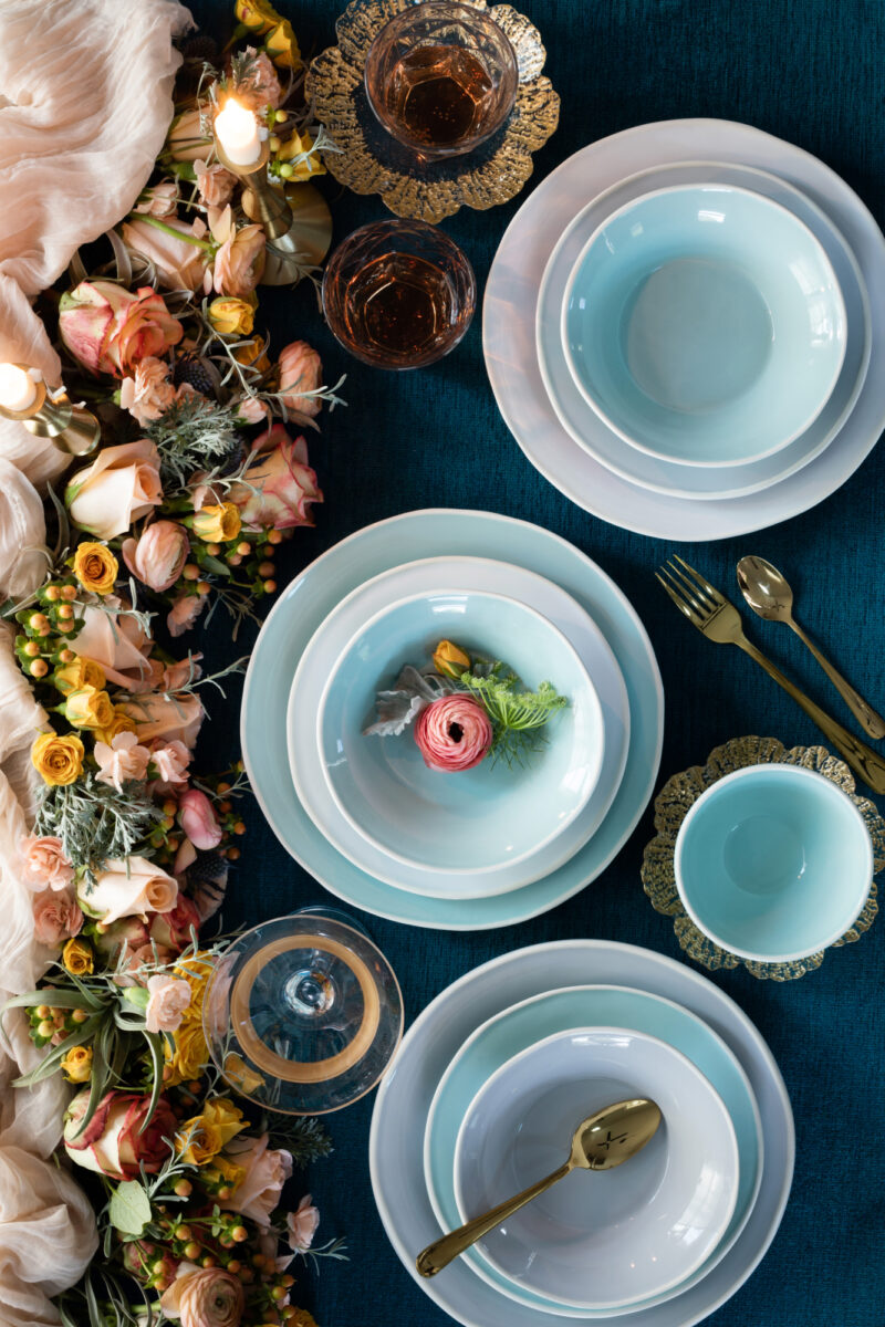 VIETRI - Light Blue Dinnerware Set on a Dark Table with Beautiful Floral Display