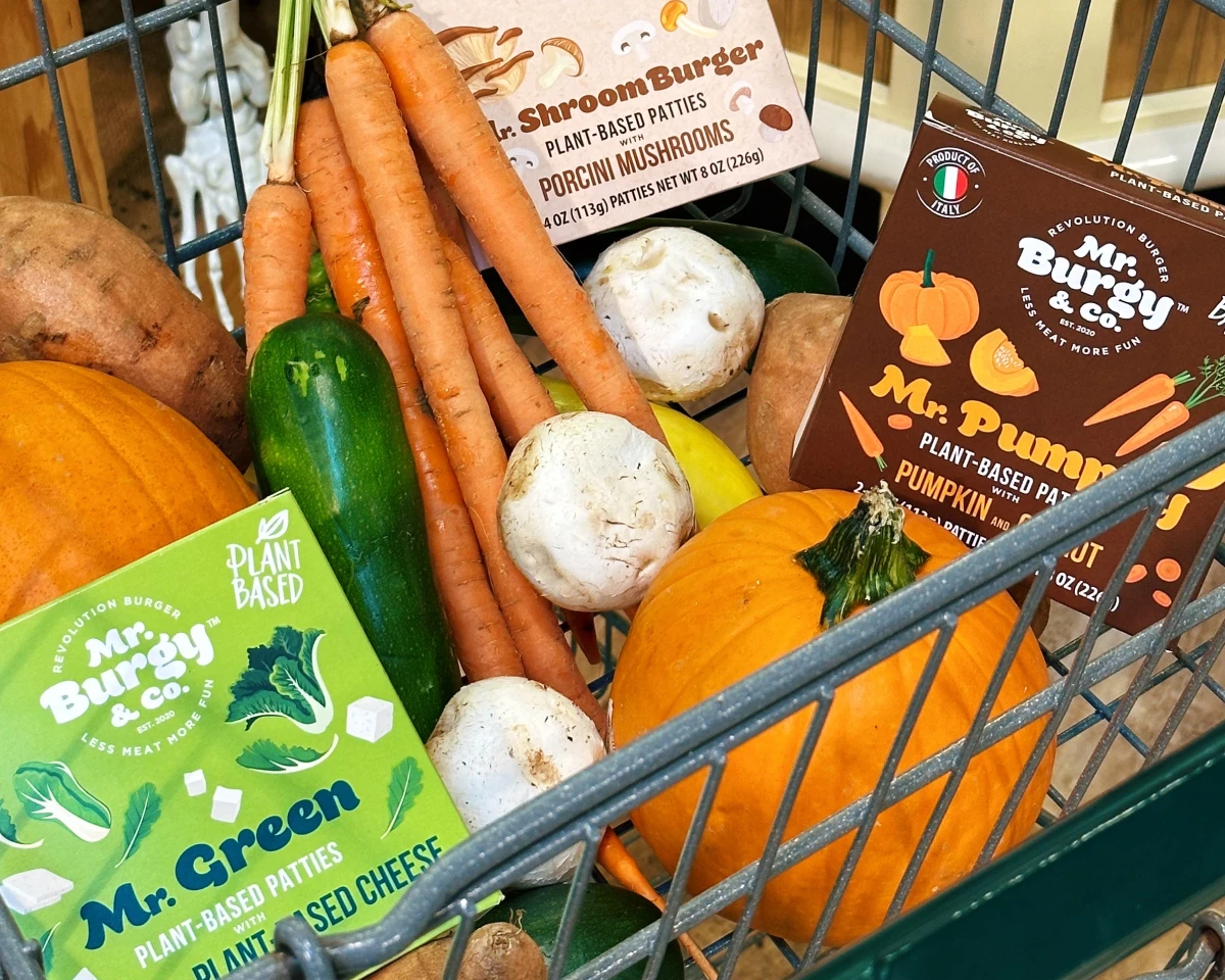 Mr Burgy and Co plant-based patties in a shopping cart with various fall vegetables