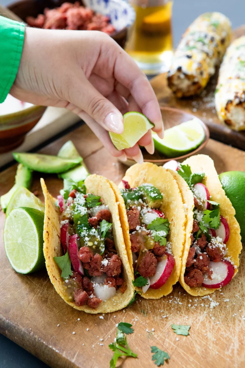 Mr Burgy and Co plant-based beef tacos in corn tortillas and a squeeze of lime